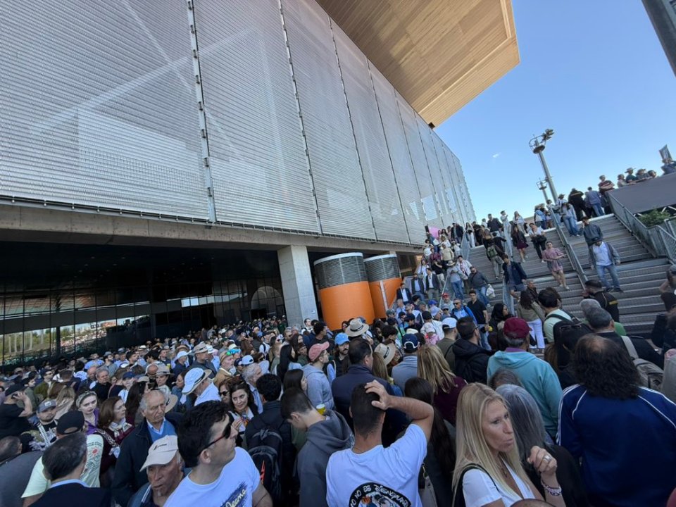 Large crowd outside a building during a power outage.